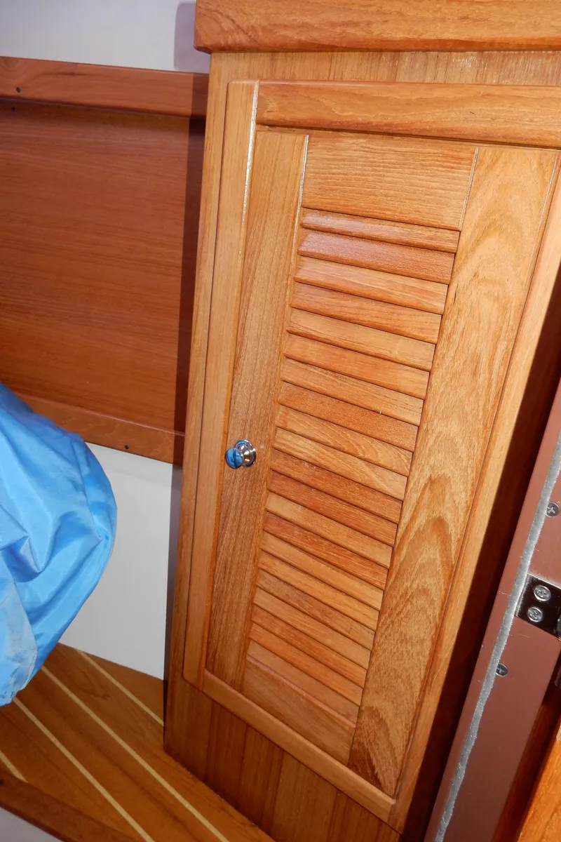 Slide: The Image of Wooden cabinet door inside a 2004 Catalina 350 sailboat interior. - 39
