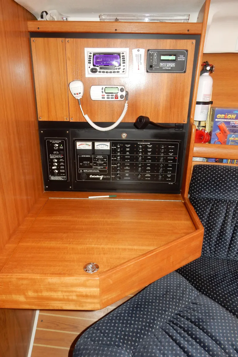 Slide: The Image of Navigation station of a 2004 Catalina 350 sailboat with control panels and radio equipment. - 41