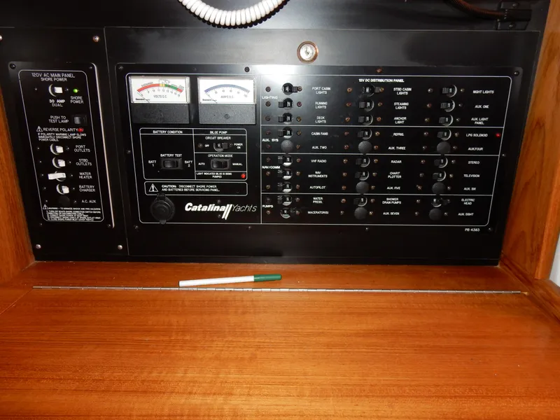 Slide: The Image of Electrical control panel of a 2004 Catalina 350 yacht with gauges and switches. - 42