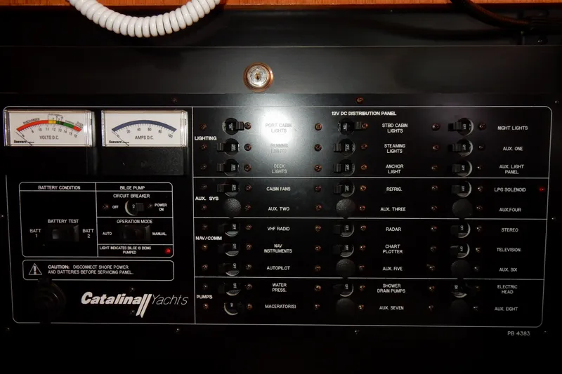 Slide: The Image of Electrical control panel of a 2004 Catalina 350 yacht with various switches and gauges. - 43