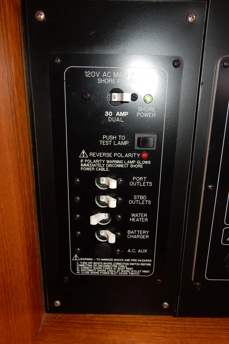 Slide: The Image of Electrical panel of a 2004 Catalina 350 boat, featuring various switches and indicators. - 44