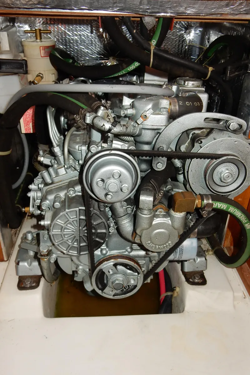 Slide: The Image of Catalina 350 2004 engine compartment with visible belts and hoses. - 46