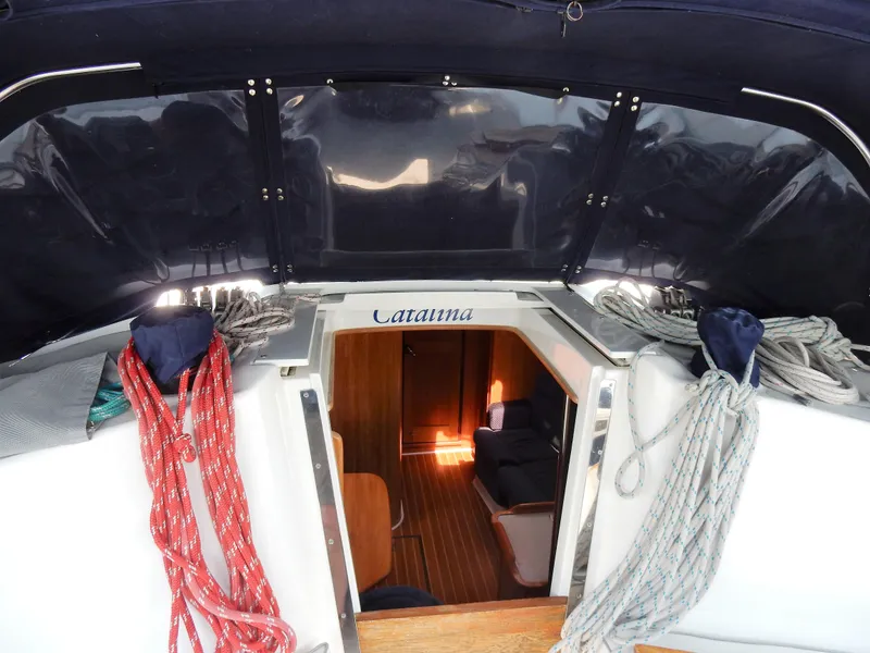 Slide: The Image of 2004 Catalina 350 sailboat interior view with ropes and cabin entrance. - 48