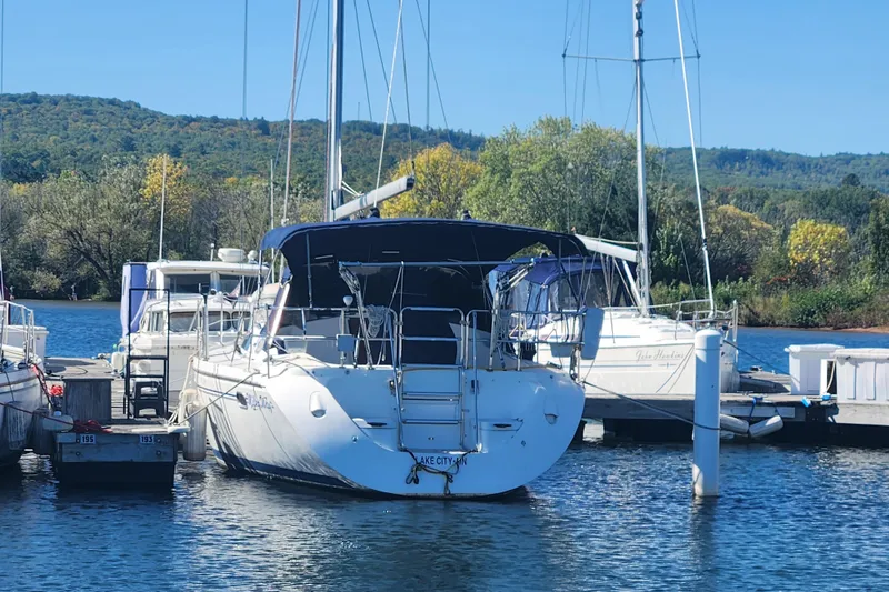 Slide: The Image of Catalina 350 sailboat docked at marina, surrounded by scenic greenery, 2004 model. - 5