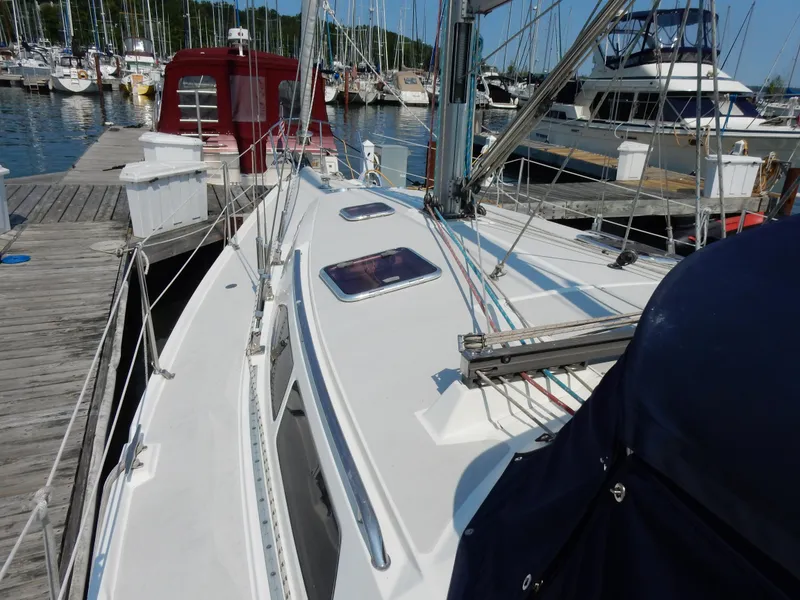 Slide: The Image of 2004 Catalina 350 sailboat docked at marina, showcasing deck and rigging. - 7