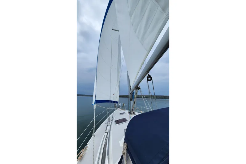 Slide: The Image of Sailing on a 2004 Catalina 350 yacht with white sails against a cloudy sky. - 78