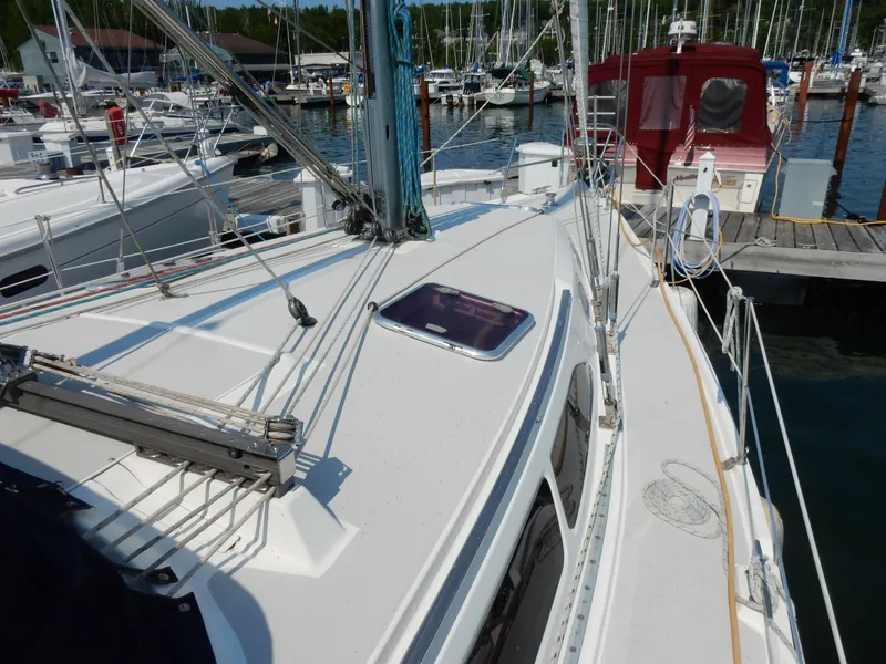 Slide: The Image of 2004 Catalina 350 sailboat docked at marina, showcasing deck and rigging. - 8