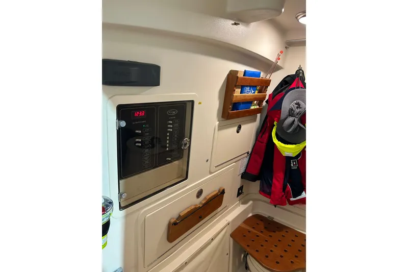 Slide: The Image of 2019 Grady-White Canyon 336 cabin interior with control panel and storage. - 10