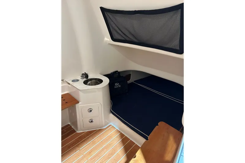 Slide: The Image of 2019 Grady-White Canyon 336 cabin interior with sink and seating area. - 12