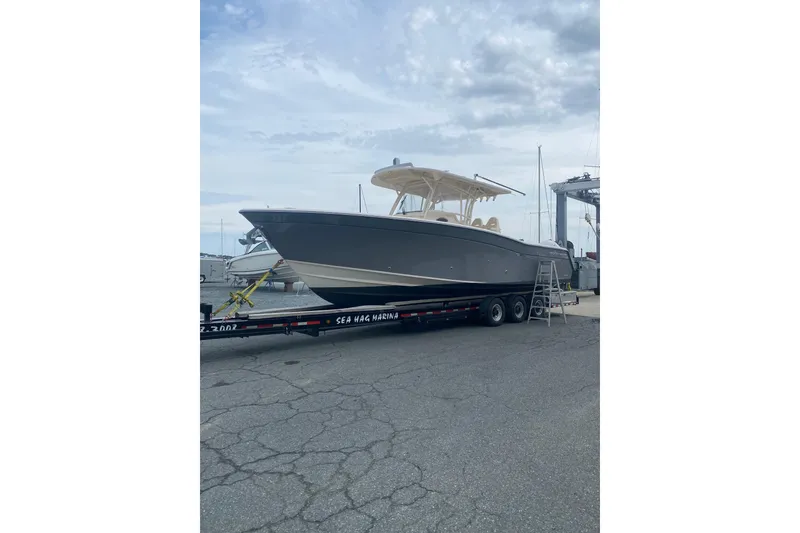 Slide: The Image of 2019 Grady-White Canyon 336 boat on trailer at marina, overcast sky. - 17
