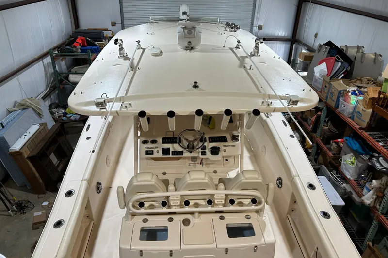 Slide: The Image of 2019 Grady-White Canyon 336 boat in storage, showcasing helm and seating area. - 3
