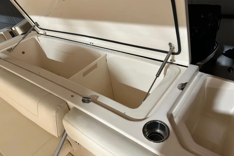Slide: The Image of 2019 Grady-White Canyon 336 boat storage compartment with open lid and cup holder. - 9