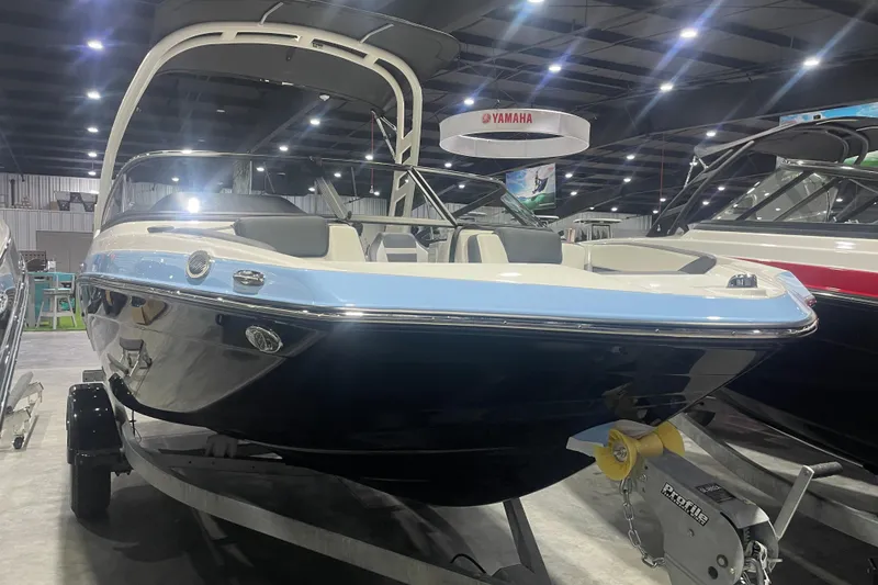 Slide: The Image of 2025 Yamaha Boats 195S on display in a showroom, showcasing sleek design and modern features. - 1