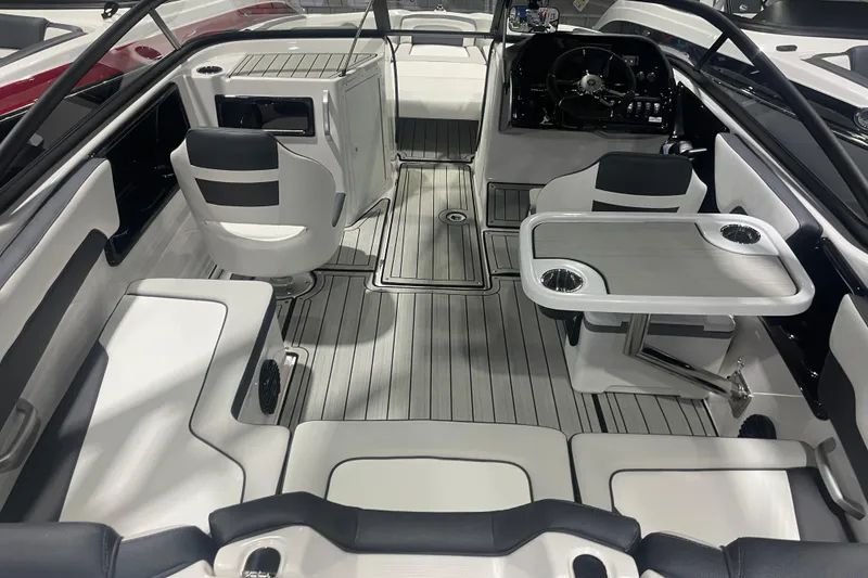 Slide: The Image of 2025 Yamaha Boats 195S interior with seating, table, and steering console. - 5
