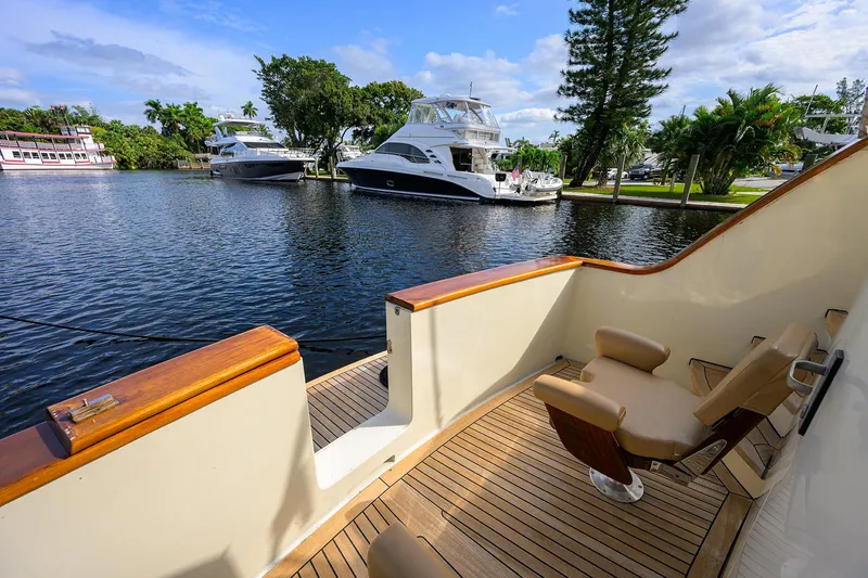 Slide: The Image of 1991 Hatteras 78 CMY yacht deck with scenic waterfront view. - 14