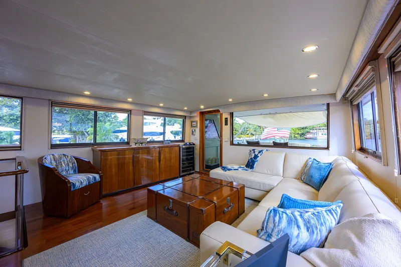 Slide: The Image of Luxurious interior of 1991 Hatteras 78 CMY yacht with elegant seating and wooden accents. - 21