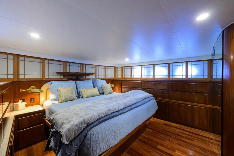 Slide: The Image of Luxurious bedroom interior on 1991 Hatteras 78 CMY yacht with wood paneling and cozy bedding. - 31