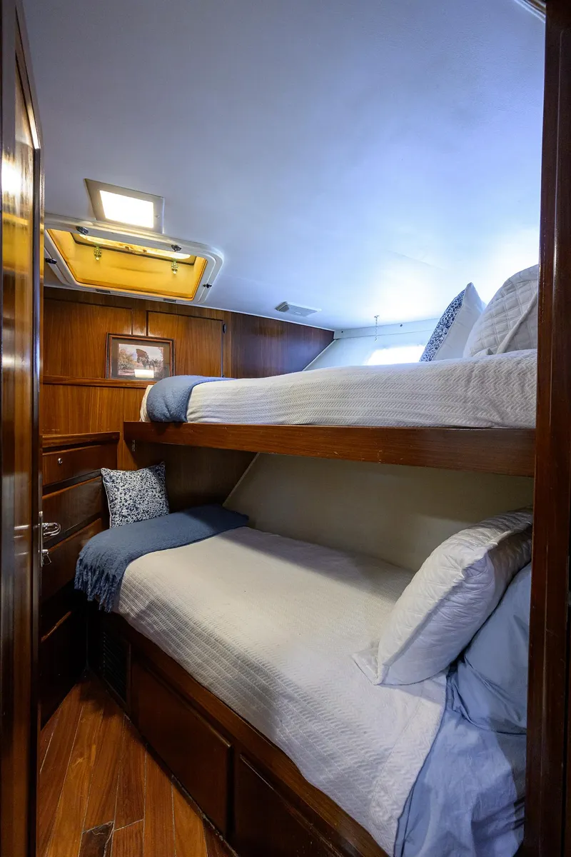 Slide: The Image of Cozy bunk beds in 1991 Hatteras 78 CMY yacht cabin with wooden interior. - 40