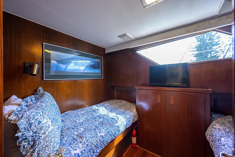 Slide: The Image of Cozy cabin interior of 1991 Hatteras 78 CMY yacht with twin beds and TV. - 43