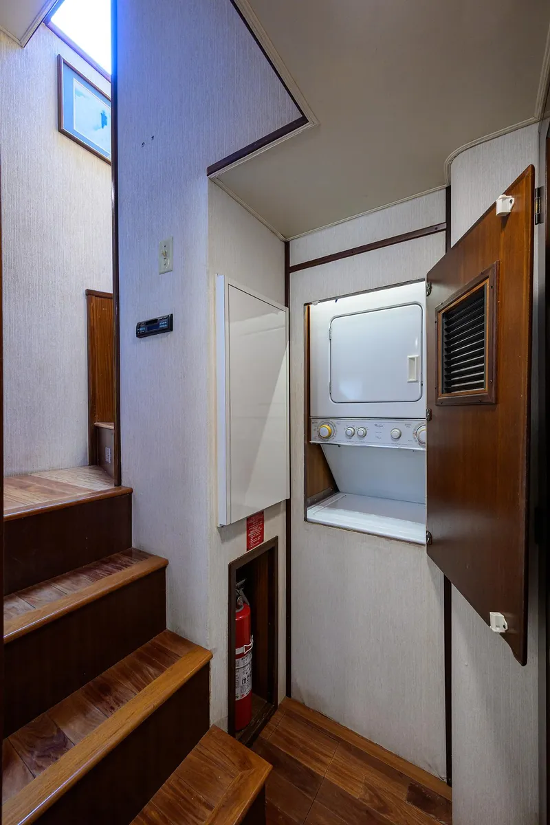 Slide: The Image of Laundry area on 1991 Hatteras 78 CMY yacht with stacked washer and dryer. - 47