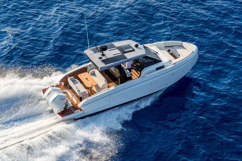 The Image of 2026 Beneteau Gran Turismo 35 cruising on open blue sea, aerial view. - 0