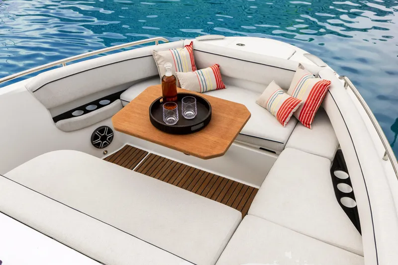 Slide: The Image of 2026 Beneteau Gran Turismo 35 boat interior with cozy seating and striped cushions. - 11
