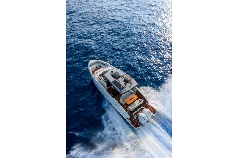 Slide: The Image of 2026 Beneteau Gran Turismo 35 cruising on open blue sea, aerial view. - 4