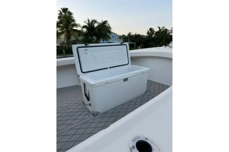 Slide: The Image of Open YETI cooler on 2007 Parker 2501 Center Console boat deck, with palm trees in background. - 10