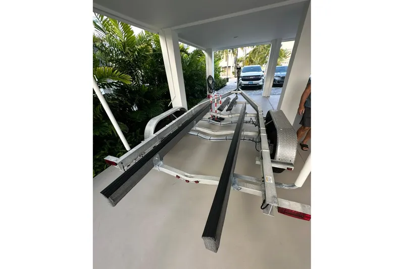 Slide: The Image of Trailer for 2007 Parker 2501 Center Console boat parked under a carport. - 12