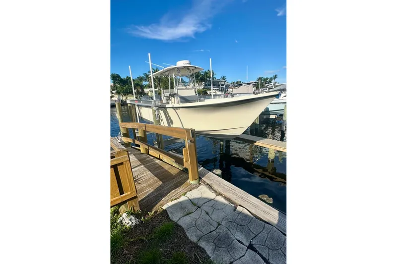 Slide: The Image of 2007 Parker 2501 Center Console boat docked on a sunny day. - 2
