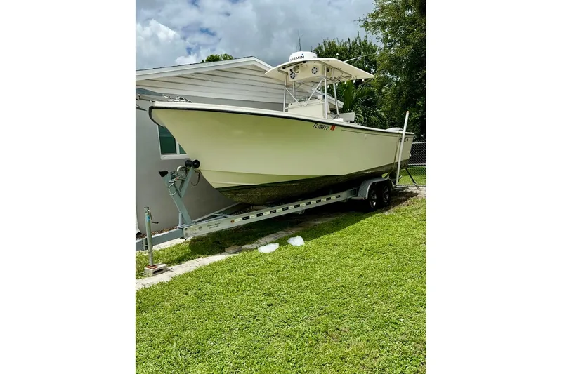 Slide: The Image of 2007 Parker 2501 Center Console boat on trailer, parked on grass. - 3