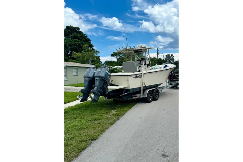 Slide: The Image of 2007 Parker 2501 Center Console boat on trailer with twin outboard motors. - 5