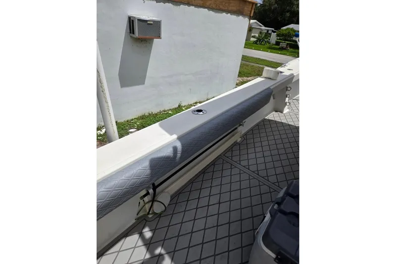 Slide: The Image of 2007 Parker 2501 Center Console boat interior with cushioned seating and diamond-patterned flooring. - 9