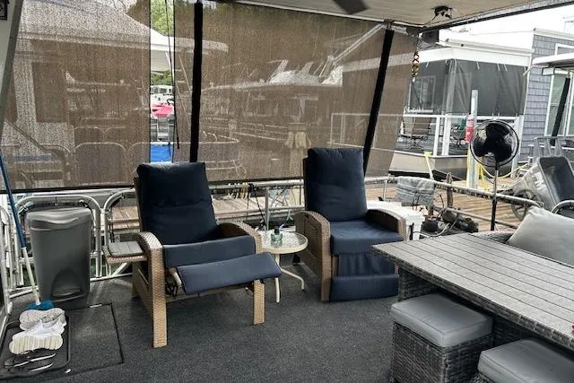 Slide: The Image of 1987 Somerset Houseboat 14X60 on water, featuring shaded windows and railing. - 13