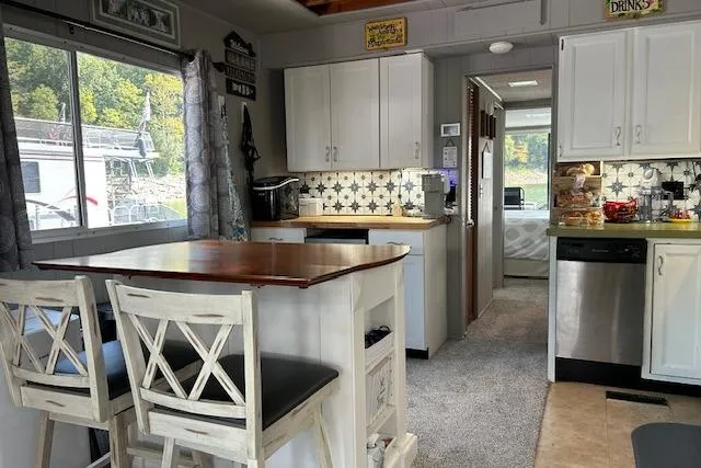 Slide: The Image of Bathroom in 1987 Somerset Houseboat, featuring shower, toilet, and shelves with towels. - 19