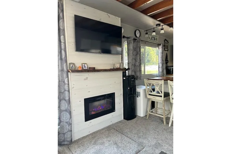 Slide: The Image of Kitchen interior of a 1987 Somerset Houseboat, featuring modern appliances and white cabinetry. - 20
