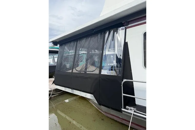 Slide: The Image of 1987 Somerset Houseboat 14X60 "Blu Star" docked, featuring white exterior and blue star logo. - 3