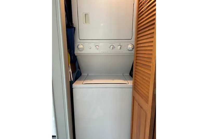 Slide: The Image of Cozy bedroom in 1987 Somerset Houseboat, featuring a large bed and scenic window view. - 31