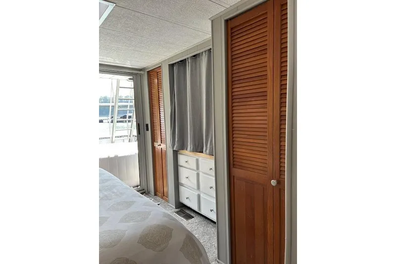 Slide: The Image of Stacked washer and dryer in 1987 Somerset Houseboat, model 14X60, with wooden louvered door. - 32