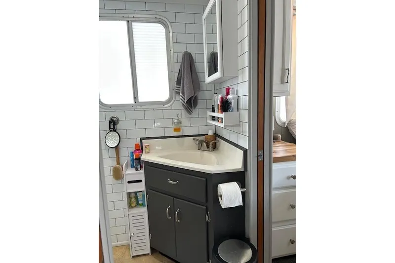 Slide: The Image of Bathroom interior of 1987 Somerset Houseboat, featuring modern sink and storage. - 34