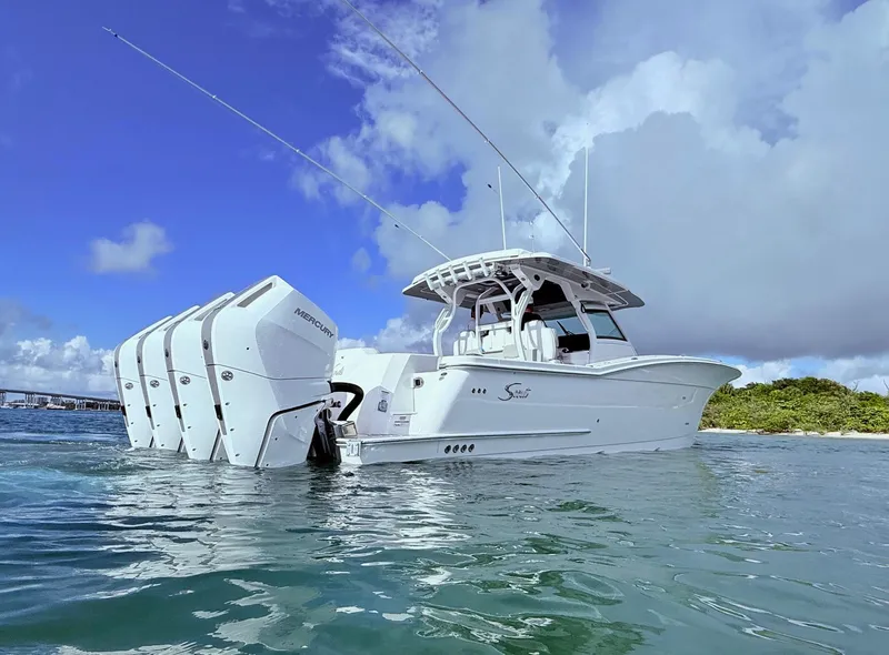 Slide: The Image of 2024 Scout 400 LXF boat with multiple outboard engines on water. - 13