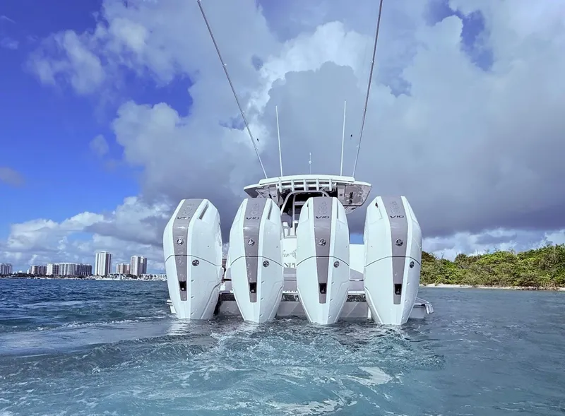 Slide: The Image of 2024 Scout 400 LXF boat with four powerful outboard engines on the water. - 15