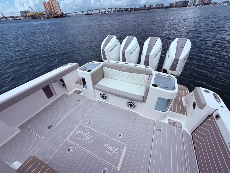 Slide: The Image of 2024 Scout 400 LXF boat deck with seating and multiple Mercury engines. - 21