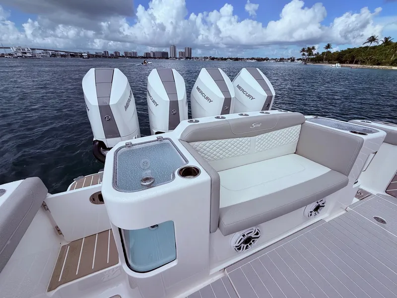 Slide: The Image of 2024 Scout 400 LXF boat with Mercury engines, luxurious seating, and ocean view. - 25