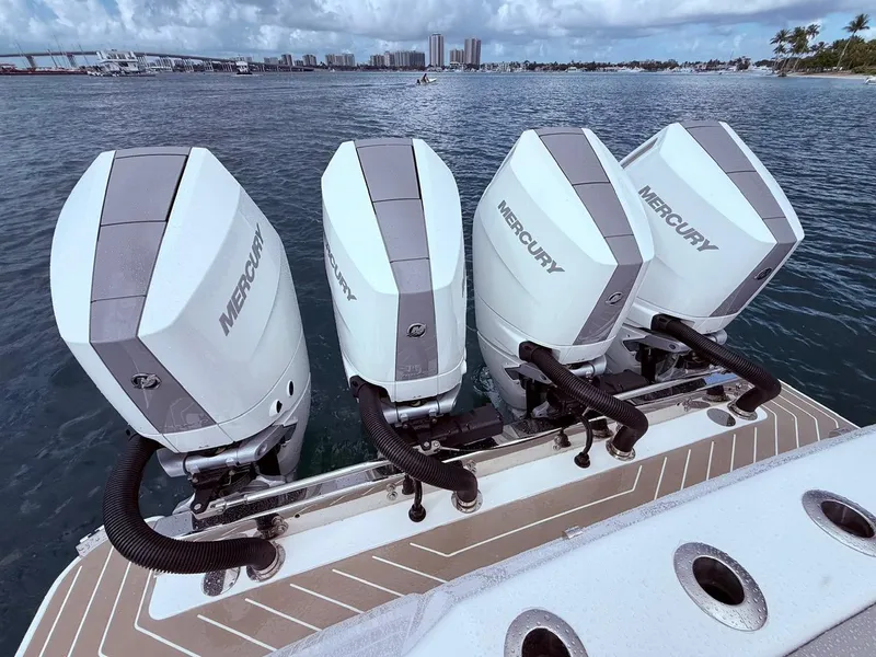 Slide: The Image of Four Mercury outboard engines on a 2024 Scout 400 LXF boat, ocean backdrop. - 28