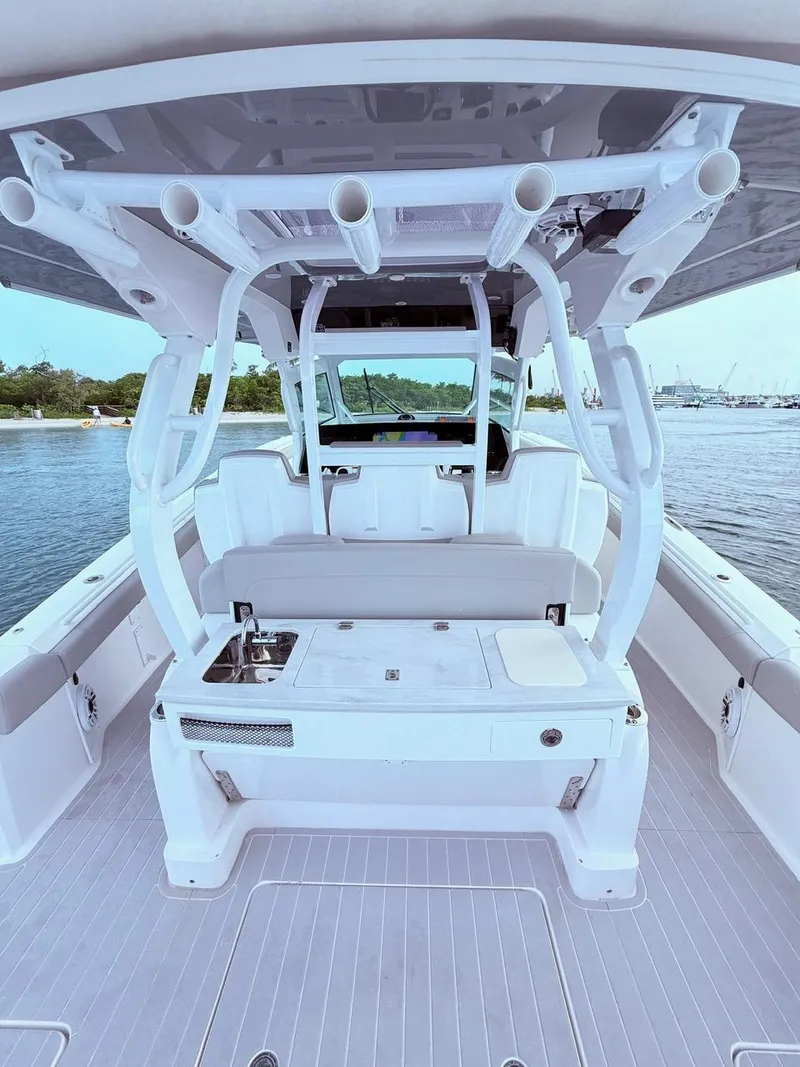 Slide: The Image of 2024 Scout 400 LXF boat interior with seating and fishing rod holders. - 31