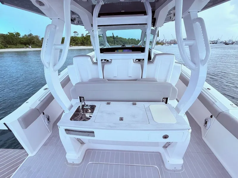 Slide: The Image of 2024 Scout 400 LXF boat interior with seating and sink, docked by the water. - 32