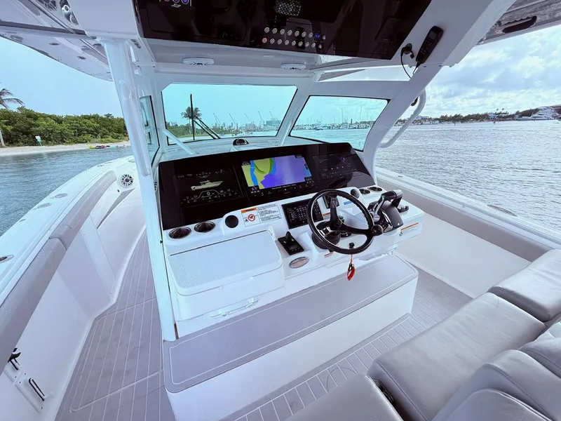 Slide: The Image of 2024 Scout 400 LXF boat helm with advanced navigation system and luxurious seating. - 34