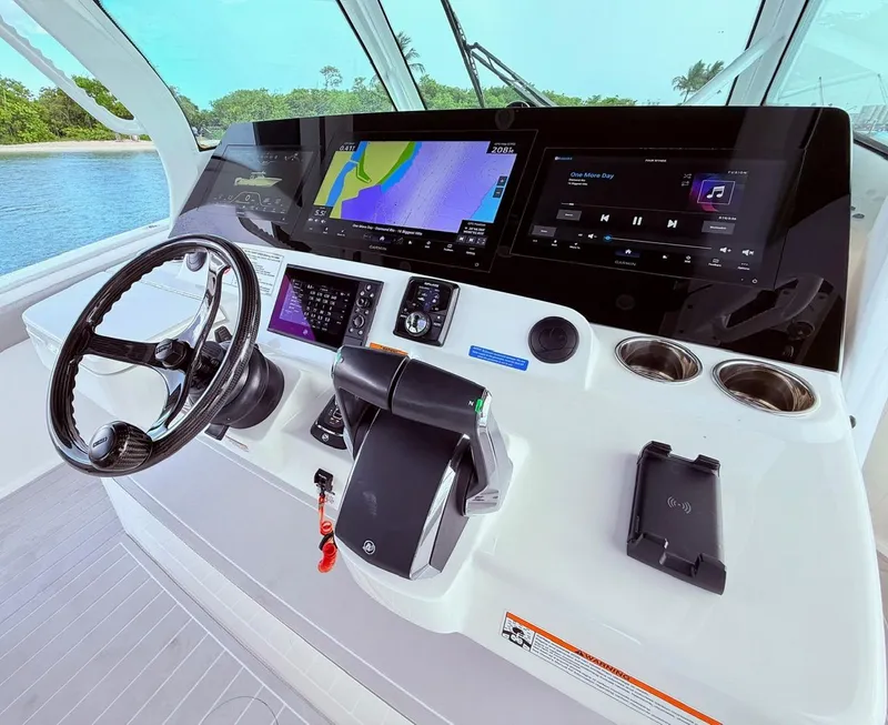 Slide: The Image of 2024 Scout 400 LXF boat dashboard with advanced navigation and control systems. - 37