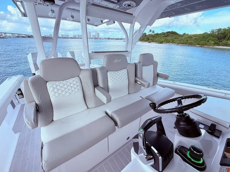 Slide: The Image of 2024 Scout 400 LXF boat interior with luxurious seating and modern controls. - 39